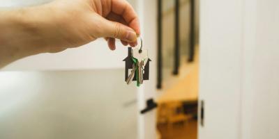 a hand holding a key to a door 