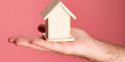 person holding brown miniature house 