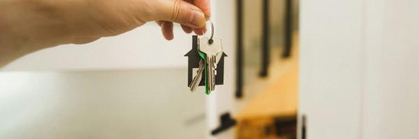 a hand holding a key to a door 